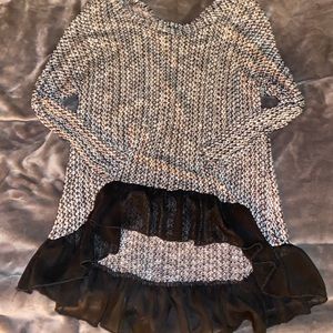 Black and white sweater with ruffle detail.